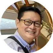 Pastor June Mesias smiling in a professional setting